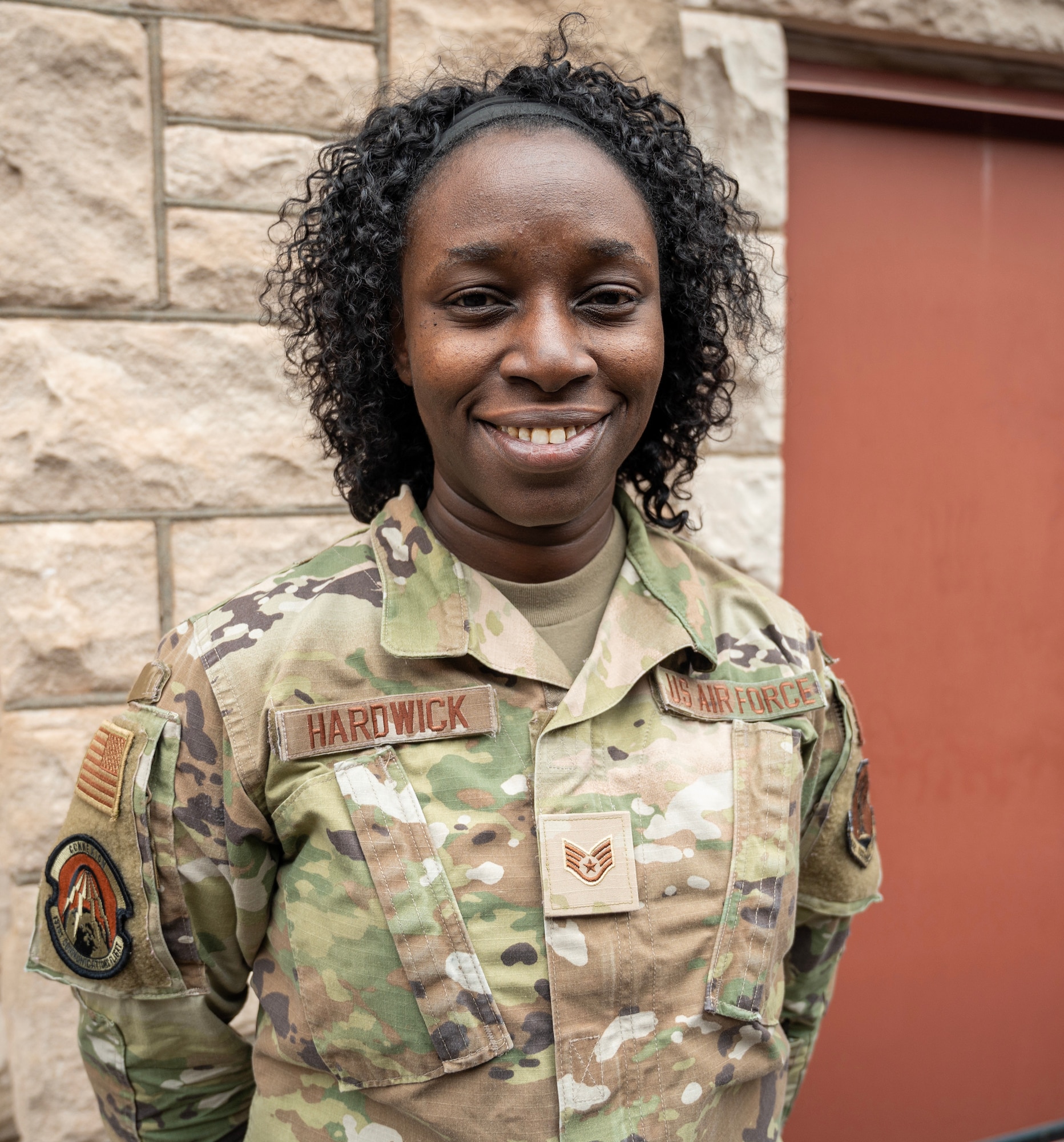 A U.S. Air Force Airman poses for a photo. She is wearing an OCP pattern uniform.