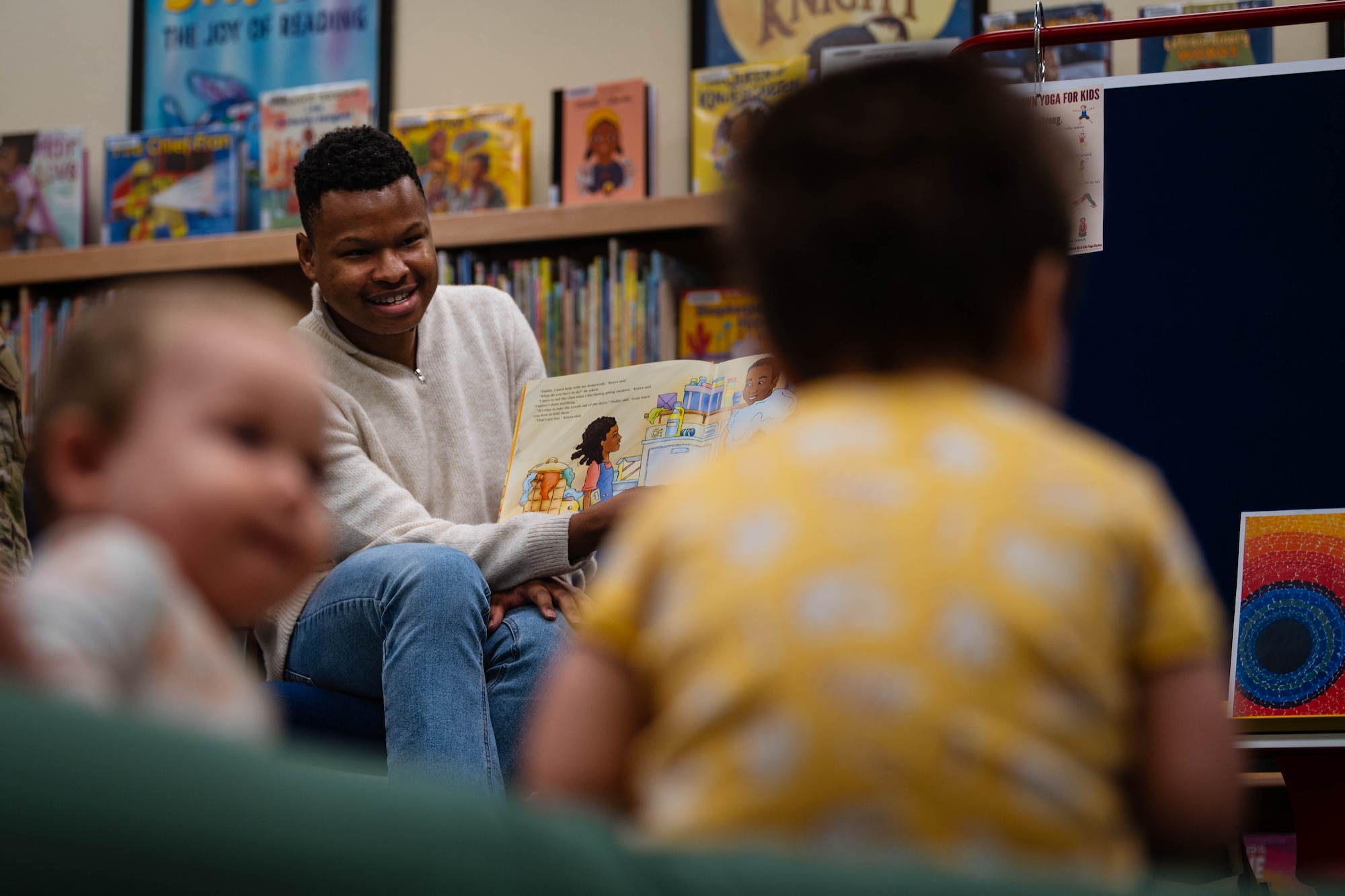 U.S. Air Force Staff Sgt. Reginald Dean, 56th Component Maintenance Squadron weapon systems coordinator, reads to children and their parents during a Black History Month story-time event at the base library.