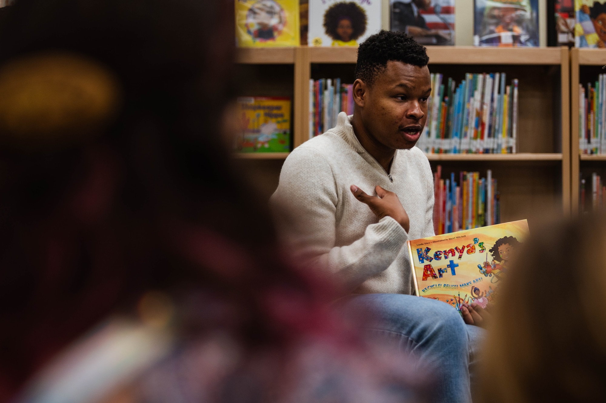 U.S. Air Force Staff Sgt. Reginald Dean, 56th Component Maintenance Squadron weapon systems coordinator, reads to children and their parents during a Black History Month story-time event at the base library.