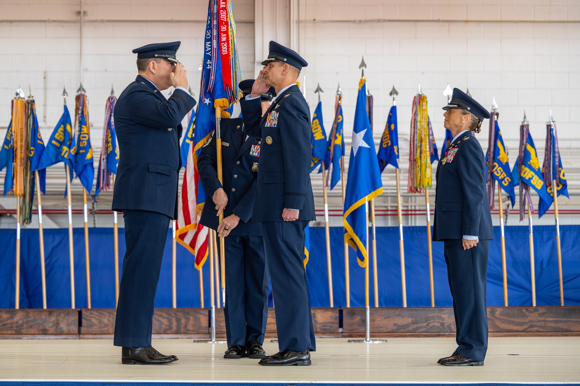 U.S. Air Force Lt. Gen. Tony Bauernfeind, Air Force Special Operations Command commander, left, renders a salute after passing command to Col. Patrick Dierig, 1st Special Operations Wing commander, middle, as Col. Allison Black, 1st SOW outgoing commander, right, stands at the position of attention during the 1st SOW change of command ceremony at Hurlburt Field, Florida, Feb. 23, 2024.