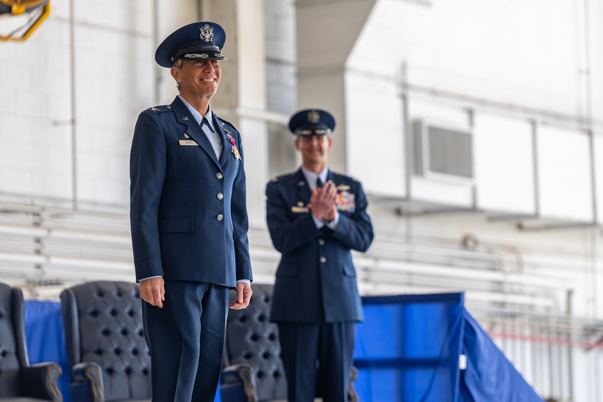 U.S. Air Force Col. Allison Black, 1st Special Operations Wing outgoing commander, stands for applause at the 1st SOW change of command ceremony at Hurlburt Field, Florida, Feb. 23, 2024.