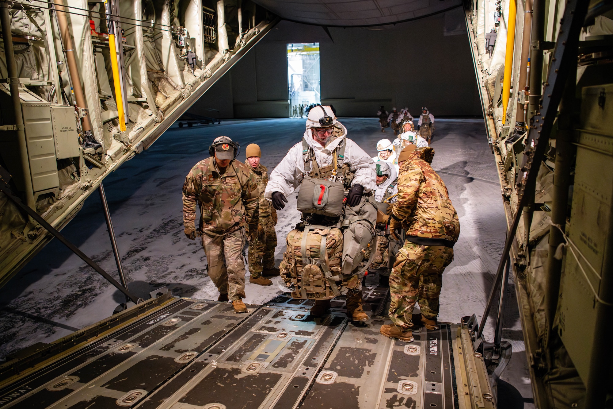 Paratroopers from the U.S. Army 2nd Infantry Brigade Combat Team, 11th Airborne Division, board a C-130J Super Hercules in preparation for a joint forcible entry exercise during Joint Pacific Multinational Readiness Center 24-02 at Joint Base Elmendorf-Richardson, Alaska.