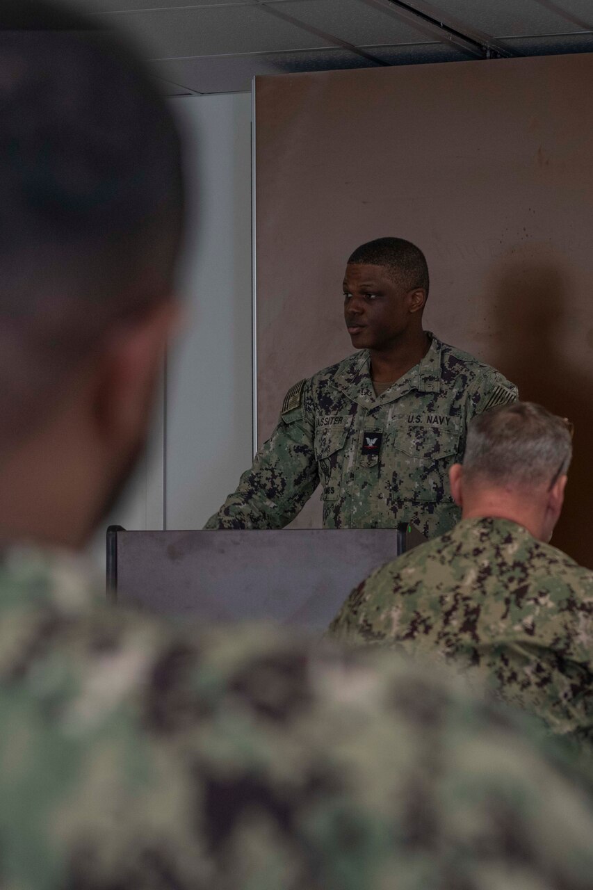 Construction Electrician 3rd Class Sean Lassiter, assigned to the Public Works Department, Naval Support Activity Souda Bay, talks about prominent African American figures in U.S. History during a Black History Month celebration held by the Multicultural Committee on Feb. 22, 2024.