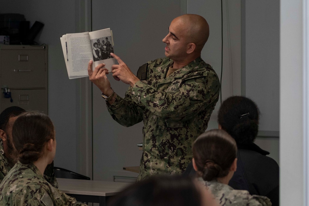 Command Master Chief Rafael Barney, Naval Support Activity Souda Bay, talks about the book Navigating the Seven Seas: Leadership Lessons of the First African American Father and Son to Serve at the Top in the U.S. Navy during a Black History Month celebration held by the Multicultural Committee on Feb. 22, 2024.
