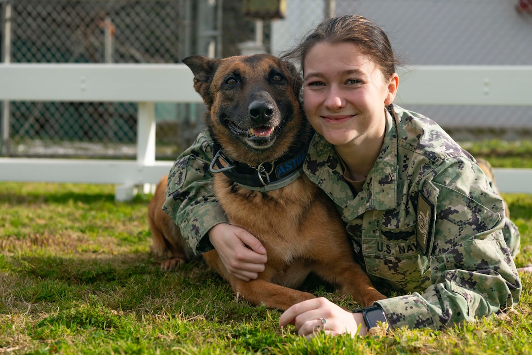 Master-at-Arms 3rd Class Kylie Odea, assigned to Naval Support Activity Souda Bay, holds Military Working Dog Astra during a Semiannual Regional Assessment onboard NSA Souda Bay on Feb. 15, 2024.