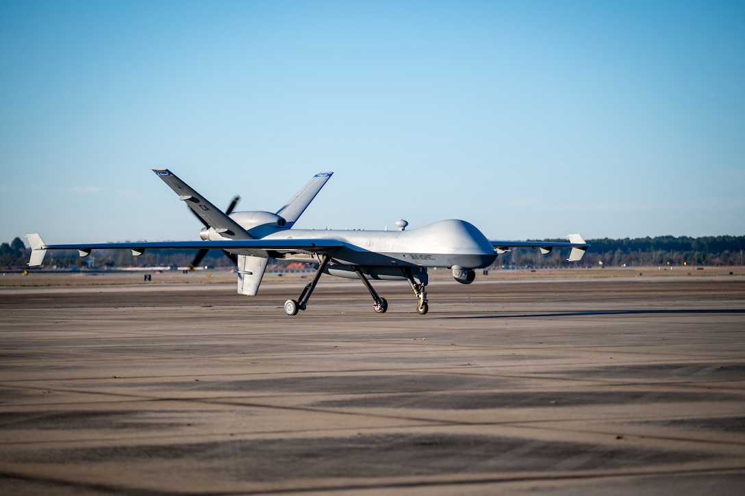 An MQ-9 Reaper taxis on a runway.