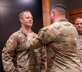 Col. Shawn Nokes, Commander, 129th Regiment (Regional Training Institute) presents Sgt. Maj. Kevin Driscoll, 129th RTI’s operations sergeant major, with the Meritorious Service Medal during Driscoll’s retirement ceremony Feb. 24 at the Illinois Military Academy, Camp Lincoln in Springfield, Illinois.