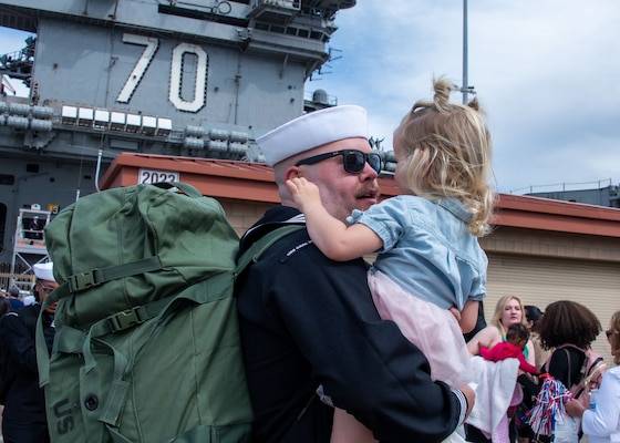 LS2 Chris Lorey hugs his daughter after USS Carl Vinson (CVN 70) returns to NAS North Island from deployment.