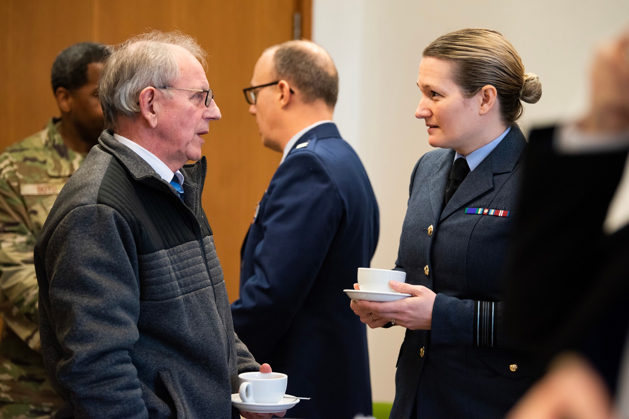 Royal Air Force Sqn. Ldr. Tina Sheeran, right, RAF commander of RAF Alconbury, RAF Croughton and RAF Molesworth, speaks with a distinguished guest after a Ceremony of Remembrance at Stanwick Lakes, England, Feb. 22, 2024. U.S. and U.K. leaders gathered to honor 17 Airmen who died in a midair collision on Feb. 22, 1944, involving B-17 Flying Fortresses from the 303rd Bombardment Group at RAF Molesworth and the 384th Bombardment Group at RAF Grafton Underwood. The Airmen were part of Operation Argument, or "The Big Week," targeting enemy industrial sites and aircraft facilities in Central Europe to secure Allied air superiority for the upcoming landings in France in June 1944. (U.S. Air Force photo by Staff Sgt. Jennifer Zima)