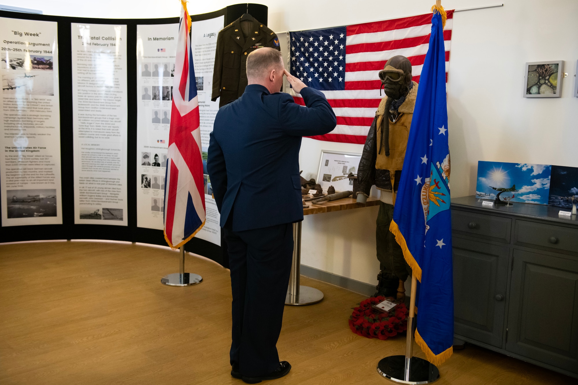U.S. Air Force Col. D. Landon Phillips, 501st Combat Support Wing commander, salutes while taps is played during wreath laying at a Ceremony of Remembrance at Stanwick Lakes, England, Feb. 22, 2024. U.S. and U.K. leaders gathered to honor 17 Airmen who died in a midair collision on Feb. 22, 1944, involving B-17 Flying Fortresses from the 303rd Bombardment Group at RAF Molesworth and the 384th Bombardment Group at RAF Grafton Underwood. The Airmen were part of Operation Argument, or "The Big Week," targeting enemy industrial sites and aircraft facilities in Central Europe to secure Allied air superiority for the upcoming landings in France in June 1944. (U.S. Air Force photo by Staff Sgt. Jennifer Zima)