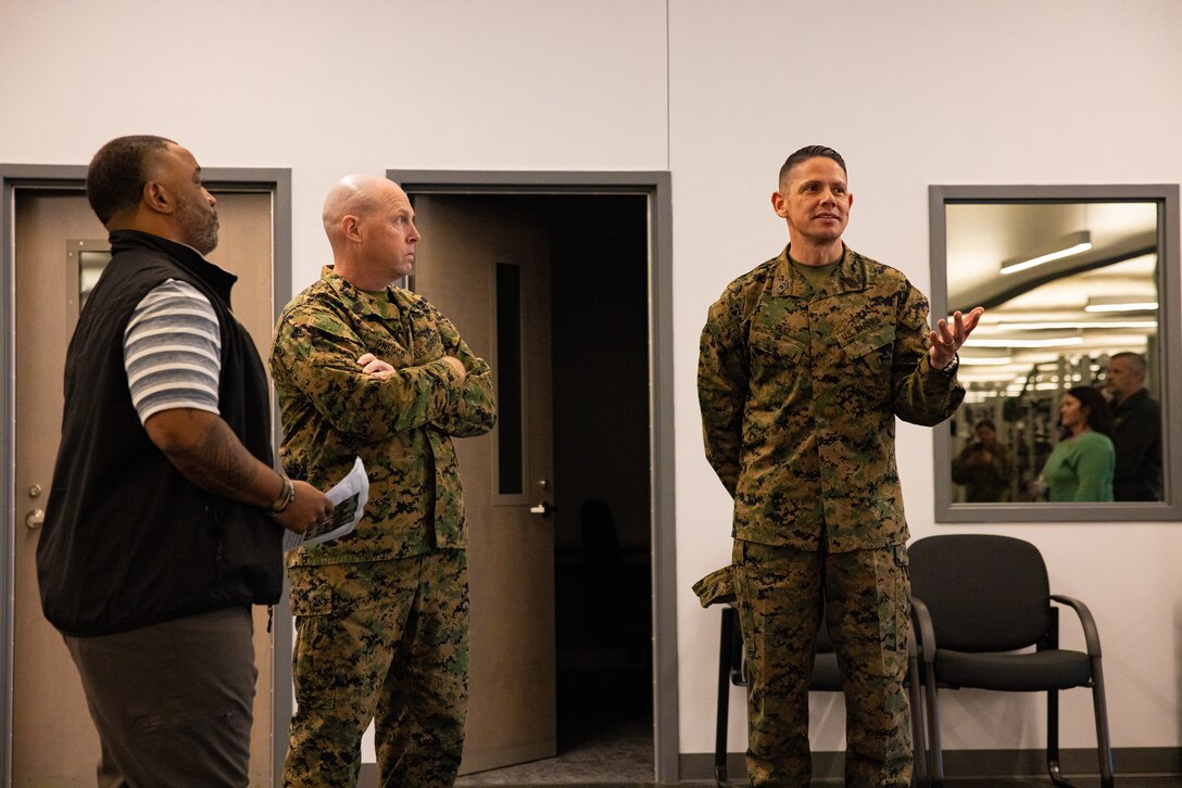 Raymond E. Anderson, director of strength and conditioning with Marine Corps Community Services, left, U.S. Marine Corps Sgt. Maj. Ryan A. Gnecco, center, sergeant major, Marine Corps Installations East-Marine Corps Base (MCB) Camp Lejeune and Sgt. Maj. Carlos A. Ruiz, Sergeant Major of the Marine Corps, right, exchange remarks in the future Warrior Athlete Readiness and Resilience Center, currently under construction, on MCB Camp Lejeune, North Carolina, Feb. 22, 2024. This facility will house a holistic, collaborative program that will enhance combat readiness in conjunction with warfighter resiliency by strengthening the mental, social, spiritual, and physical fitness necessary to overcome any challenge. (U.S. Marine Corps photo by Lance Cpl. Loriann Dauscher)