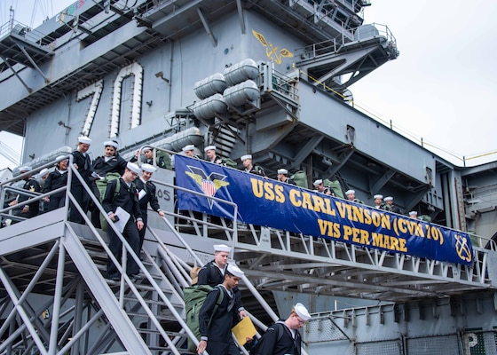 Sailors depart USS Carl Vinson (CVN 70) during a return to homeport at Naval Air Station North Island.
