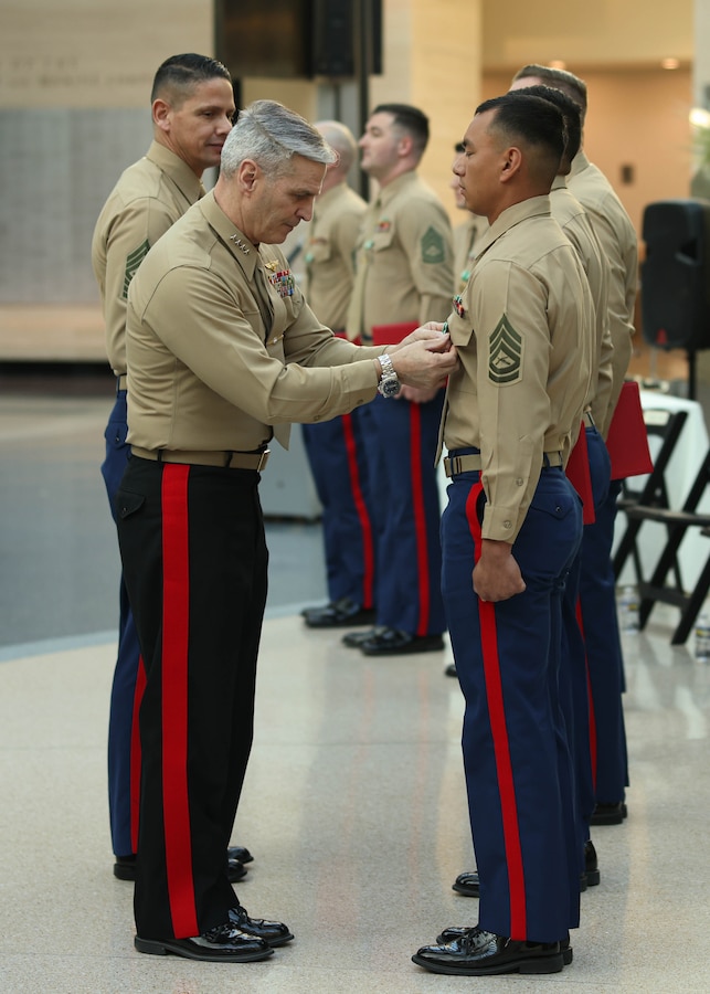 U.S. Marine Corps Gen. Christopher J. Mahoney, Assistant Commandant of the Marine Corps, left, awards Gunnery Sergeant. Russel M. Regehr, a Combat Instructor with the School of Infantry-West, as the Runner-Up Combat Instructor of the Year during the Fiscal Year 2023 Commandant’s Combined Awards Ceremony at the National Museum of the Marine Corps, Triangle, Virginia, Feb. 8, 2024. The ceremony recognized and awarded eight Marines with the Navy and Marine Corps Commendation Medal for their exceptional performance in their respective special duty assignments. (U.S. Marine Corps photo by Lance Cpl. David Brandes)