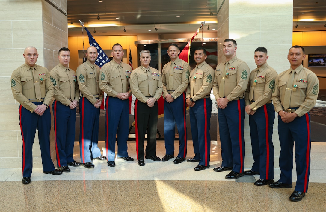 Winners of the Fiscal Year 2023 Commandant’s Combined Awards pose for a group photo with U.S. Marine Corps Gen. Christopher J. Mahoney, Assistant Commandant of the Marine Corps and Sergeant Major. Carlos A. Ruiz, Sergeant Major of the U.S. Marine Corps, at the National Museum of the Marine Corps, Triangle, Virginia, Feb. 8, 2024.  The ceremony recognized and awarded eight Marines for their exceptional performance in various special duty assignments from around the world. (U.S. Marine Corps photo by Lance Cpl. David Brandes)