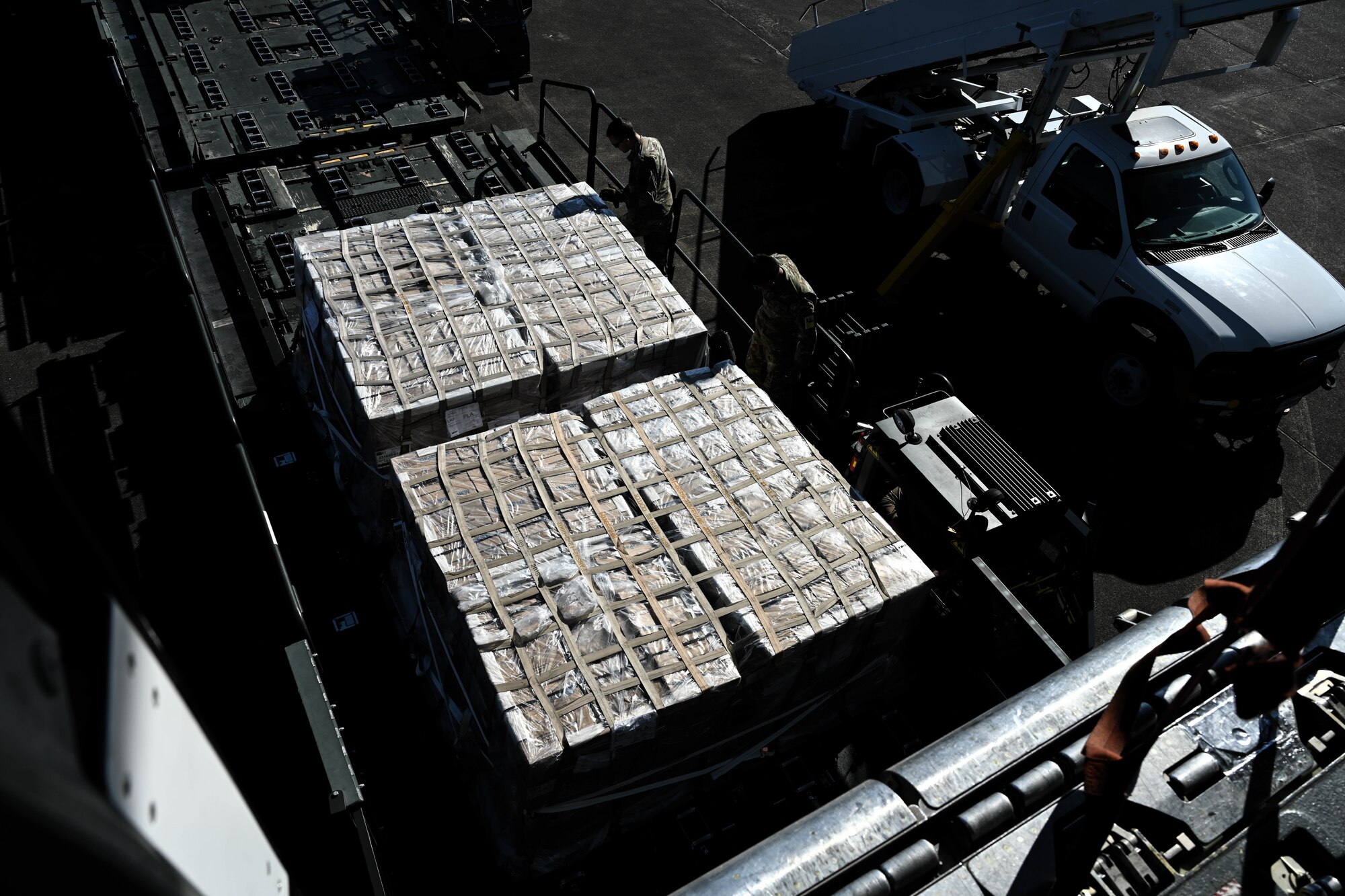 Two cargo pallets sit next to each other on a vehicle