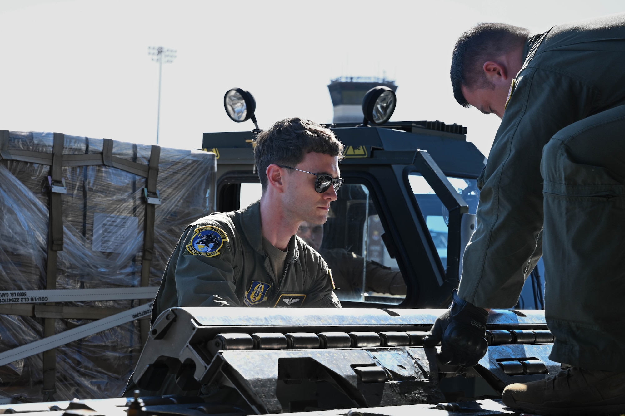 A man in uniform holds a piece of roller equipment