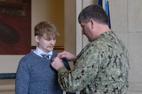 Naval Surface Warfare Center, Carderock Division Commanding Officer Capt. Matthew Tardy (right) pins Naval Architect Patrick Crowley (left) with the Department of Navy Civilian Service Achievement Medal.