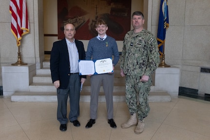 Naval Surface Warfare Center, Carderock Division Commanding Officer Capt. Matthew Tardy (right) pins Naval Architect Patrick Crowley (left) with the Department of Navy Civilian Service Achievement Medal.