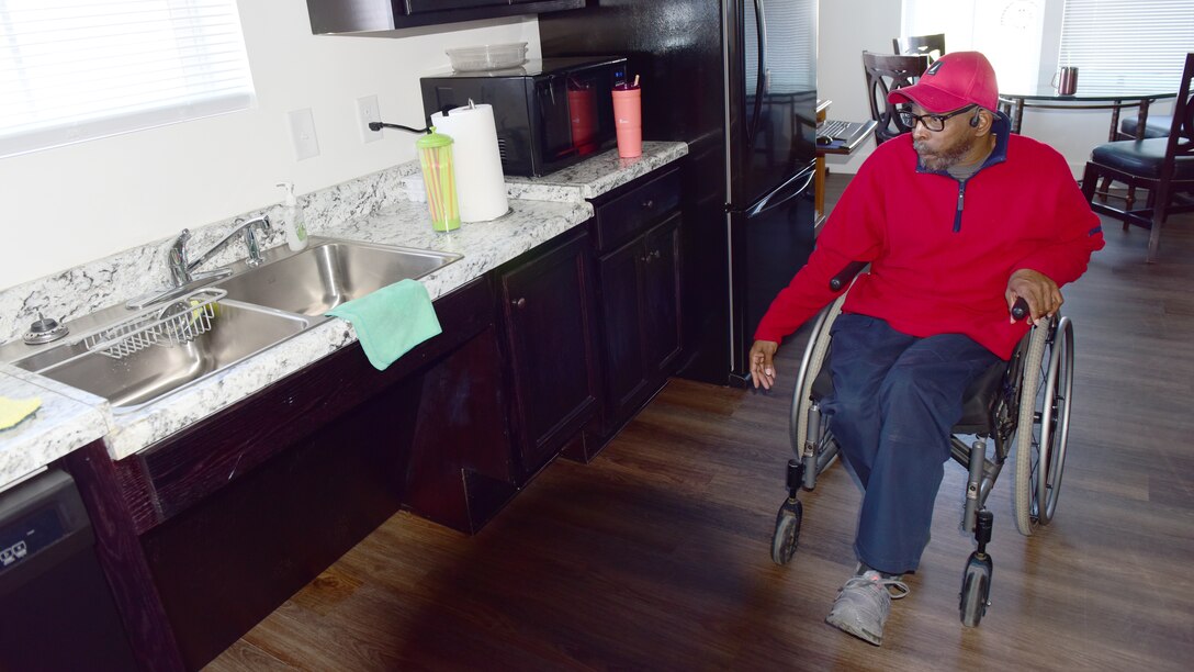 Theo Caldwell, U.S. Army Corps of Engineers Nashville District mail clerk, maneuvers in his kitchen Feb. 23, 2024, that has lower cabinets, sink, and appliances that he can reach when maneuvering in his wheelchair. He recently moved into his new Habitat for Humanity home that his coworkers and other community and corporate volunteers helped construct for him. (USACE Photo by Lee Roberts)