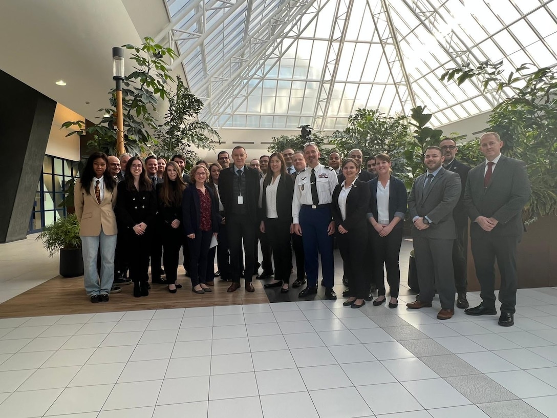 Attendees of France 101 is in the atrium at the building where the course was hosted in Nanterre, France, just outside of Paris.