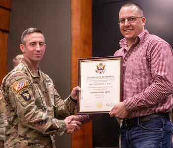 Lt. Col. Nick Camardo, Commander, 1st Battalion, 129th Regiment (Regional Training Institute) presents Master Sgt. Kenneth Ray, Branch Chief, 1st Battalion, 129th RTI, with a Certificate of Retirement during Ray’s retirement ceremony Feb. 25 at the Illinois Military Academy, Camp Lincoln in Springfield, Illinois.