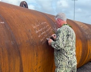 Capt. Jones signs piles Dry Dock 5 Ceremony
