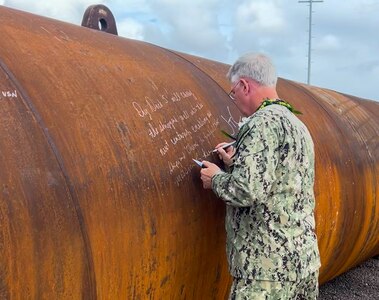 Capt. Jones signs piles Dry Dock 5 Ceremony