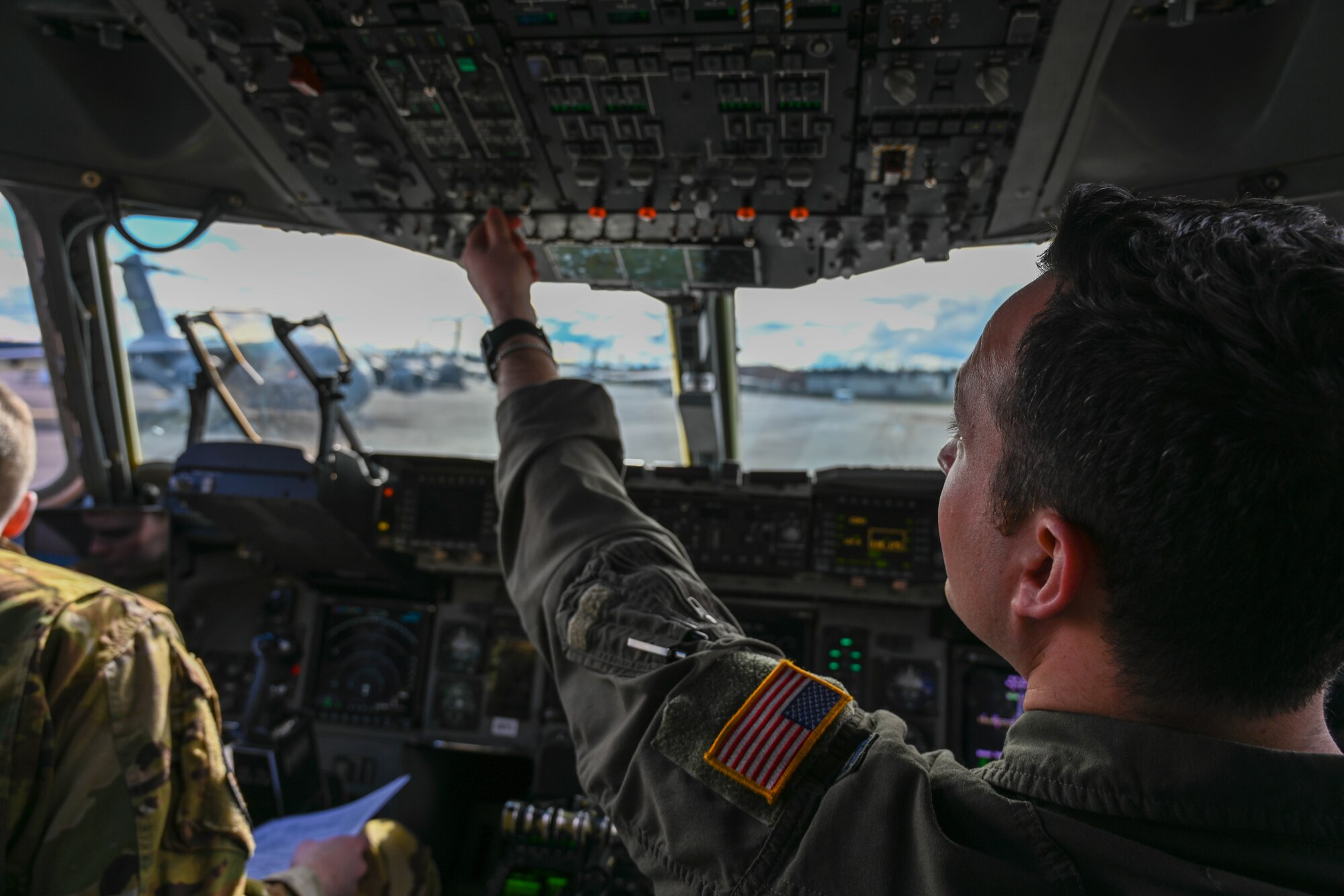U.S. Air Force Capt. Andrew Butler, 58th Airlift Squadron (AS) instructor pilot, goes through his preflight checklist before a large formation exercise (LFE) at Joint Base Lewis-McChord, Washington, Feb. 22, 2024. During the LFE, the aircrew from the 58th AS completed multiple airdrop and low level formations. (U.S. Air Force photo by Senior Airman Trenton Jancze)