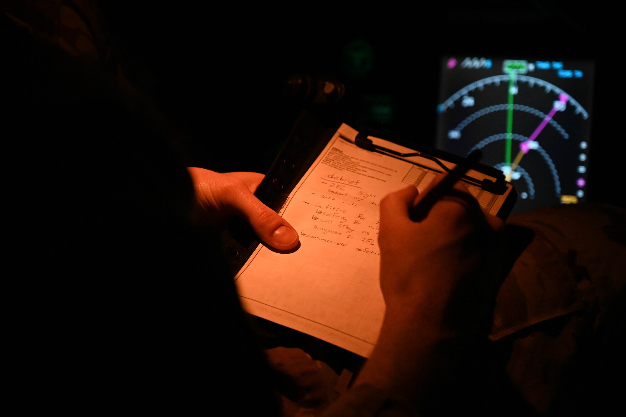 U.S. Air Force Capt. Nathan Hartman, 58th Airlift Squadron instructor pilot, writes down notes after completing a large formation exercise (LFE) at Joint Base Lewis-McChord, Washington, Feb. 22, 2024. The LFE was an opportunity to bring back essential lessons to Altus Air Force Base. (U.S. Air Force photo by Senior Airman Trenton Jancze)