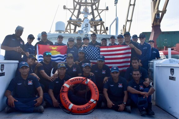 The USCGC Oliver Henry (WPC 1140) crew and shipriders from the Kiribati Police Maritime Unit (PMU) with members of the U.S. Coast Guard International Maritime Training Team stand for a photo in Tarawa, Kiribati, on Feb. 16, 2024. For the first time since 2015, the patrol incorporated shipriders from the PMU, executing the maritime bilateral agreement signed with Kiribati in 2008. These engagements under Operation Blue Pacific emphasize the United States' commitment to strengthening ties and ensuring maritime security within the Pacific community. (U.S Coast Guard photo by Lt. j.g. Nicholas Haas)