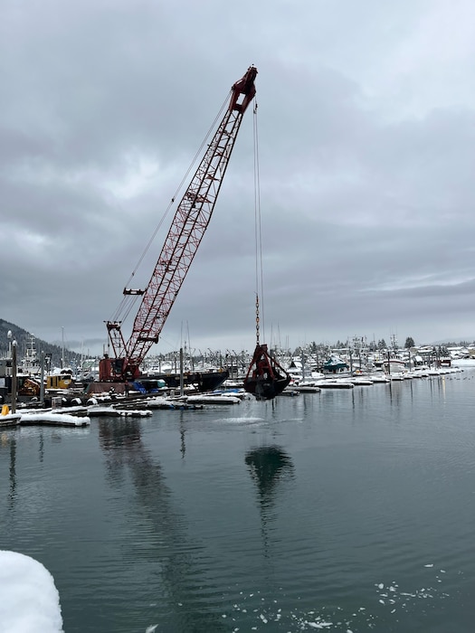 A clamshell dredge hoists shoal from the bottom of Petersburg Borough’s harbor system in southeast Alaska.
