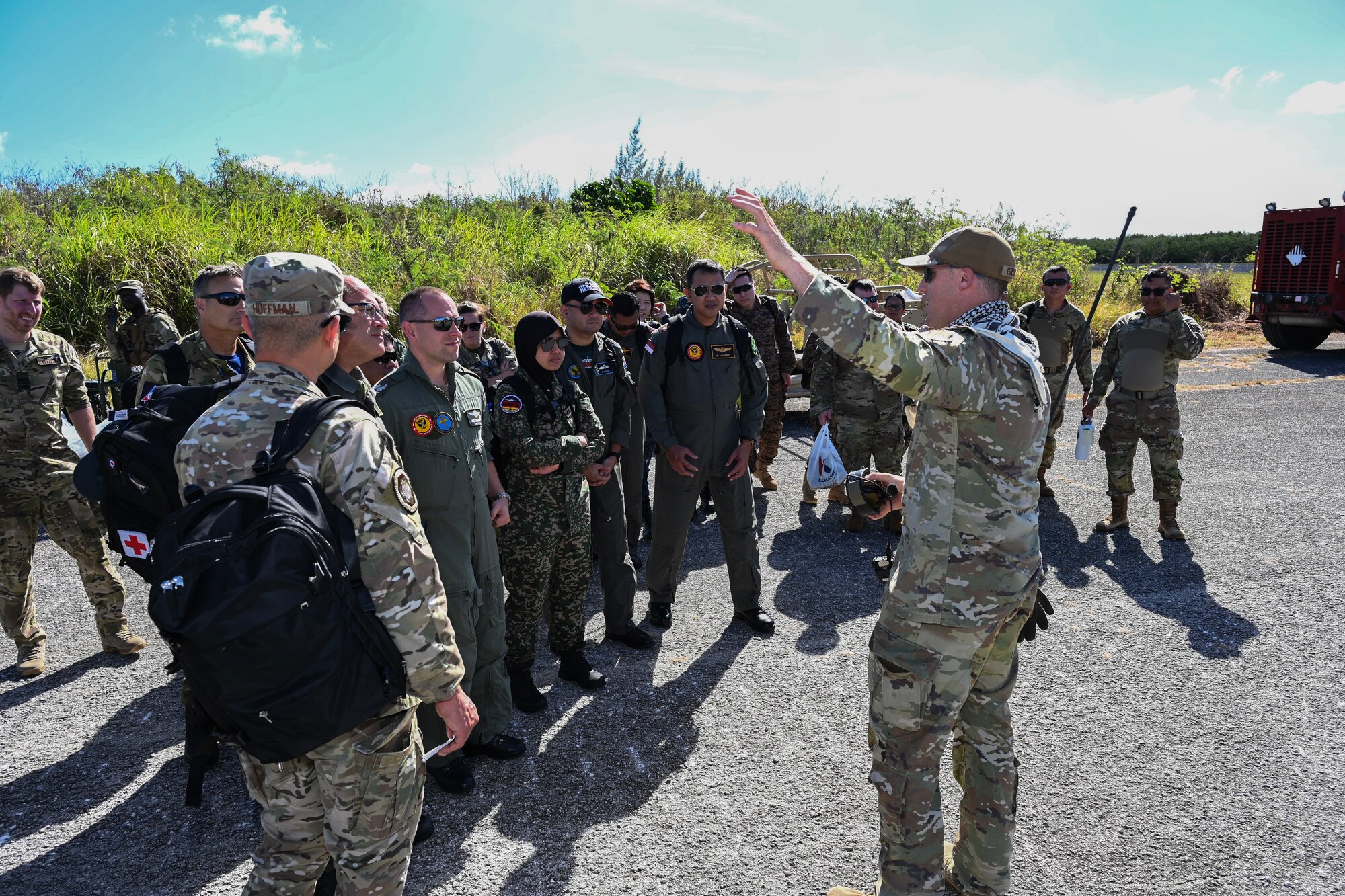 Military members from several countries gets briefed on training operations at Baker camp.