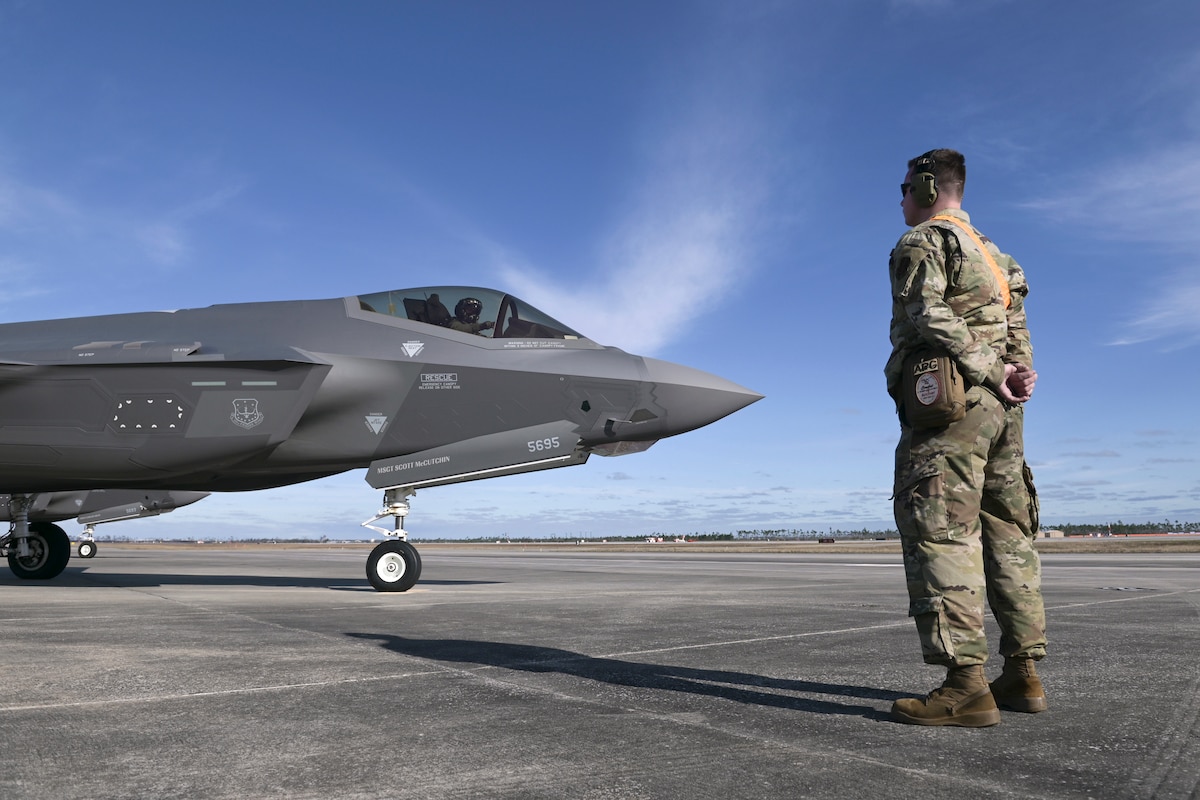 U.S. Air Force Staff Sgt. Christian Fischer, a tactical aircraft maintenance specialist with the Wisconsin Air National Guard's 115th Fighter Wing, assists an F-35A Lightning II pilot with preflight tasks February 13, 2024, during a Weapon System Evaluation Program exercise at Tyndall Air force Base, Florida.