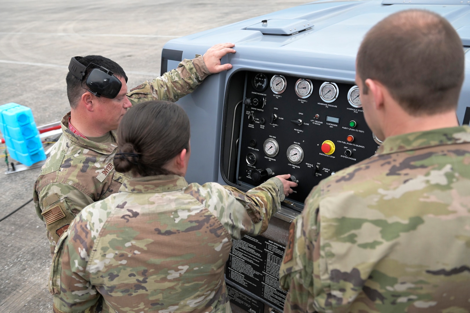 U.S. Air Force Tech Sgt. David Snyder, left, an aircrew egress systems specialist, Tech Sgt. Rebecca Mertes and Master Sgt. William McNierney, tactical aircraft maintenance specialists, all with the Wisconsin Air National Guard's 115th Fighter Wing, prepare to inflate an aircraft tire during a Weapon System Evaluation Program exercise February 15, 2024, at Tyndall Air force Base, Florida.