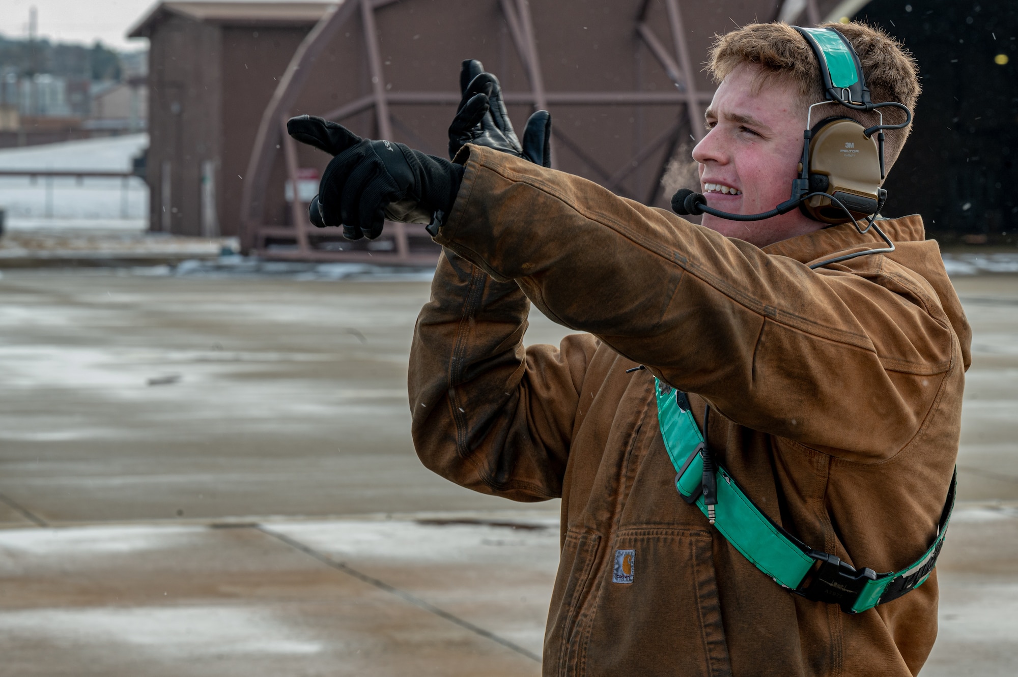 U.S. Air Force Airman 1st Class Tucker Arnold, 25th Fighter Generation Squadron crew chief, signals to a pilot prior to taxiing at Osan Air Base, Republic of Korea, Jan. 22, 2024. Crew chiefs, along with the rest of airframe, powerplant and general from the 25th FGS have many responsibilities to ensure that the planes can safely make it out to the runway. One of these responsibilities includes conducting regular foreign object debris walks in the area outside of the hangars to ensure that the aircraft are not at risk of becoming damaged prior to taxi. (U.S. Air Force photo by Airman 1st Class Chase Verzaal)