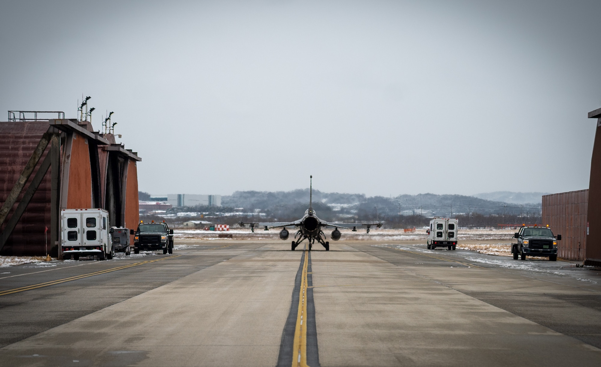 An F-16 taxis down a runway.