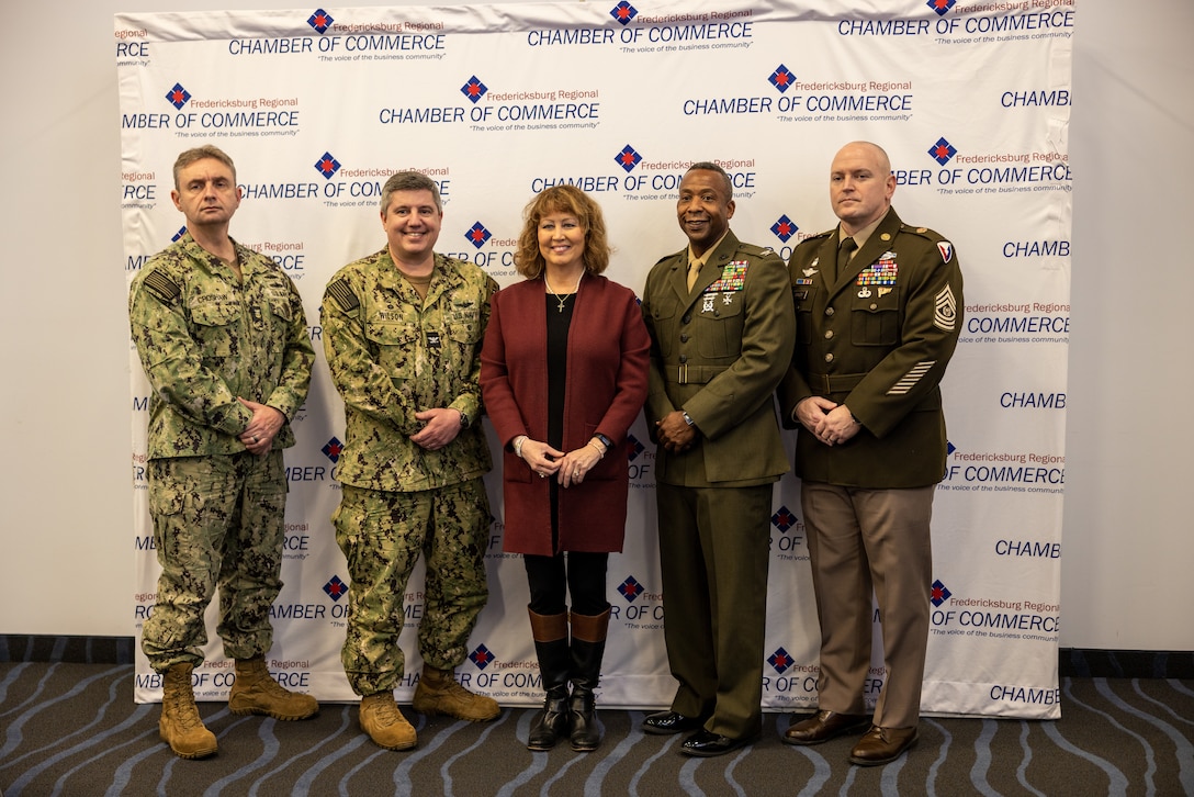 U.S. service members pose for a photo with Susan Spears, the president and CEO of Fredericksburg Regional Chamber of Commerce, center, during a board meeting at Fredericksburg, Virginia, Feb. 22. 2024. The meeting highlighted local and military relationships while emphasizing one military, one community. (U.S. Marine Corps photo by Lance Cpl. Joaquin Dela Torre)