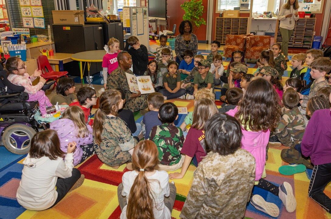 U.S. Marine Corps Col. Michael L. Brooks, commanding officer of Marine Corps Base Quantico, reads to second grade students to celebrate Read Across America Day at Crossroads Elementary School on MCB Quantico, Virginia, Feb. 26, 2023. The event is observed to encourage literacy and reading among children and teenagers, and is celebrated annually near or on Dr. Seuss’ birthday. (U.S. Marine Corps Photo by Lance Cpl. Kayla LeClaire)