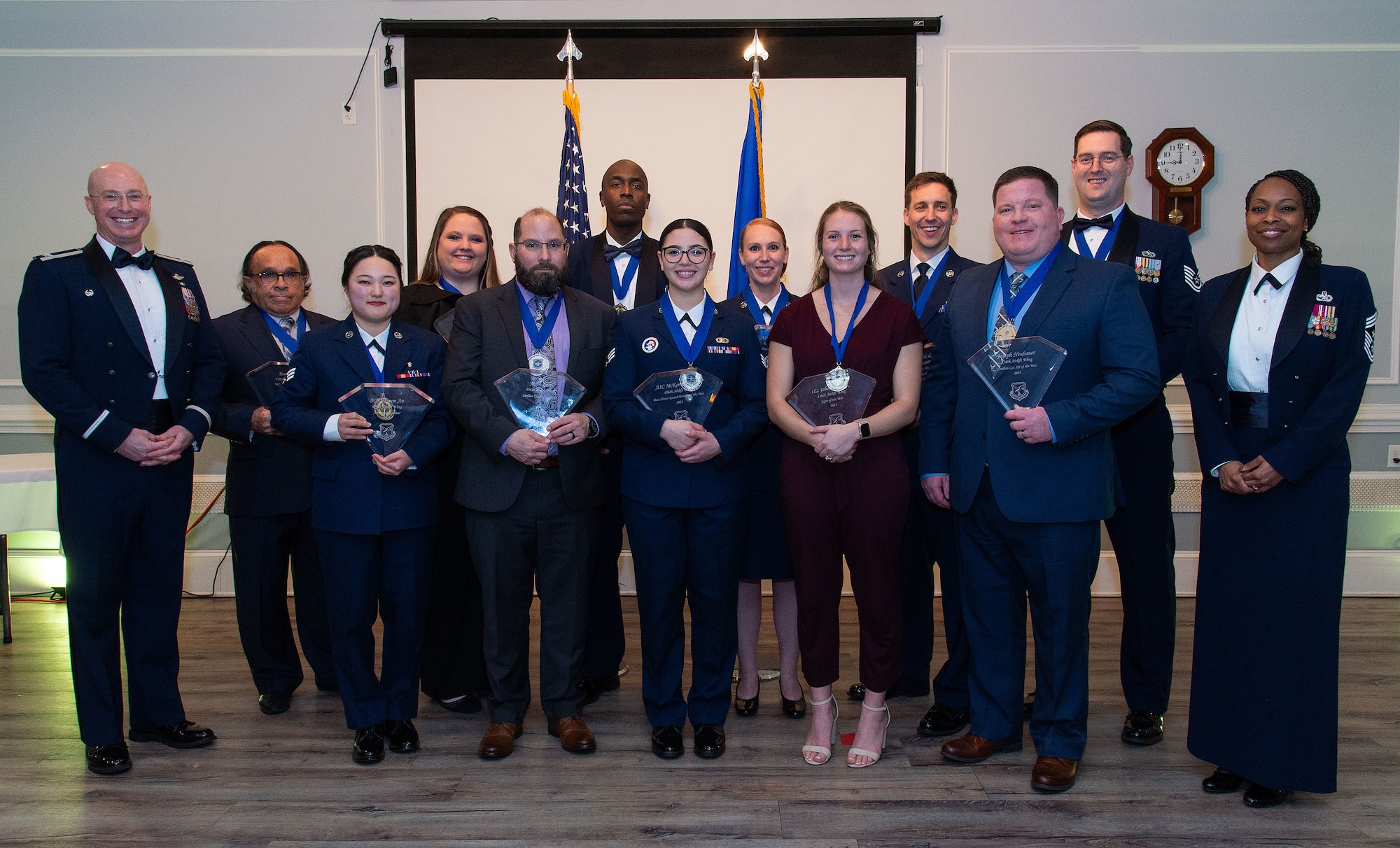 U.S. Air Force Col. Chris McDonald, left, 436th Airlift Wing commander, and U.S. Air Force Chief Master Sgt. Carolyn Russell, right, 436th AW command chief, pose with the 2023 436th AW Annual Award winners after the awards ceremony held at the Hartly Volunteer Fire Company in Hartly, Delaware, Feb. 23, 2024. Forty-seven Team Dover Airmen and five teams competed for recognition as ‘best-of-the-best’ in their respective categories. (U.S. Air Force photo by Roland Balik)