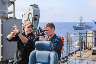Ensign James Kester, right, and Lt. j.g. Jacob Seelman monitor navigation aboard USS Carter Hall (LSD 50) in the Mediterranean Sea.