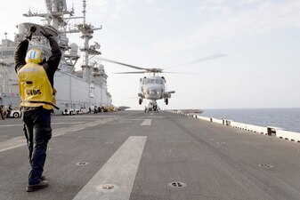 A Turkish navy S-70 helicopter departs USS Bataan (LHD 5) in the Mediterranean Sea.