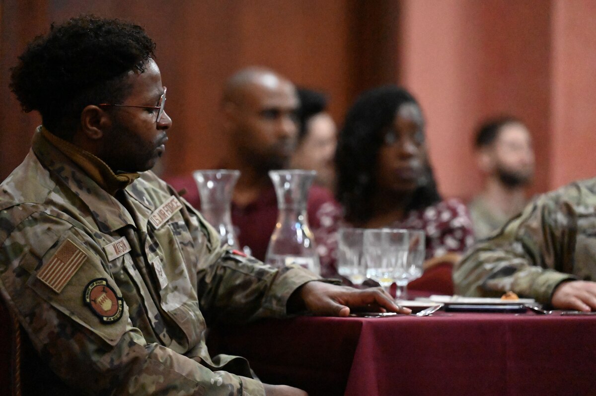 Airmen eat at the National Prayer Breakfast celebration.