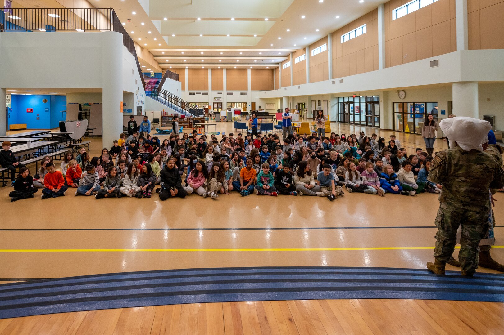 Fourth and fifth grade students at Osan Elementary School await a briefing from U.S. Airmen assigned to the 51st Medical Group dental clinic at Osan Air Base, Republic of Korea, Feb. 23, 2024. The dental clinic visited the school in honor of National Children’s Dental Health Month. They taught dental hygiene lessons followed by interactive games and prizes. (U.S. Air Force photo by Senior Airman Brittany Russell)