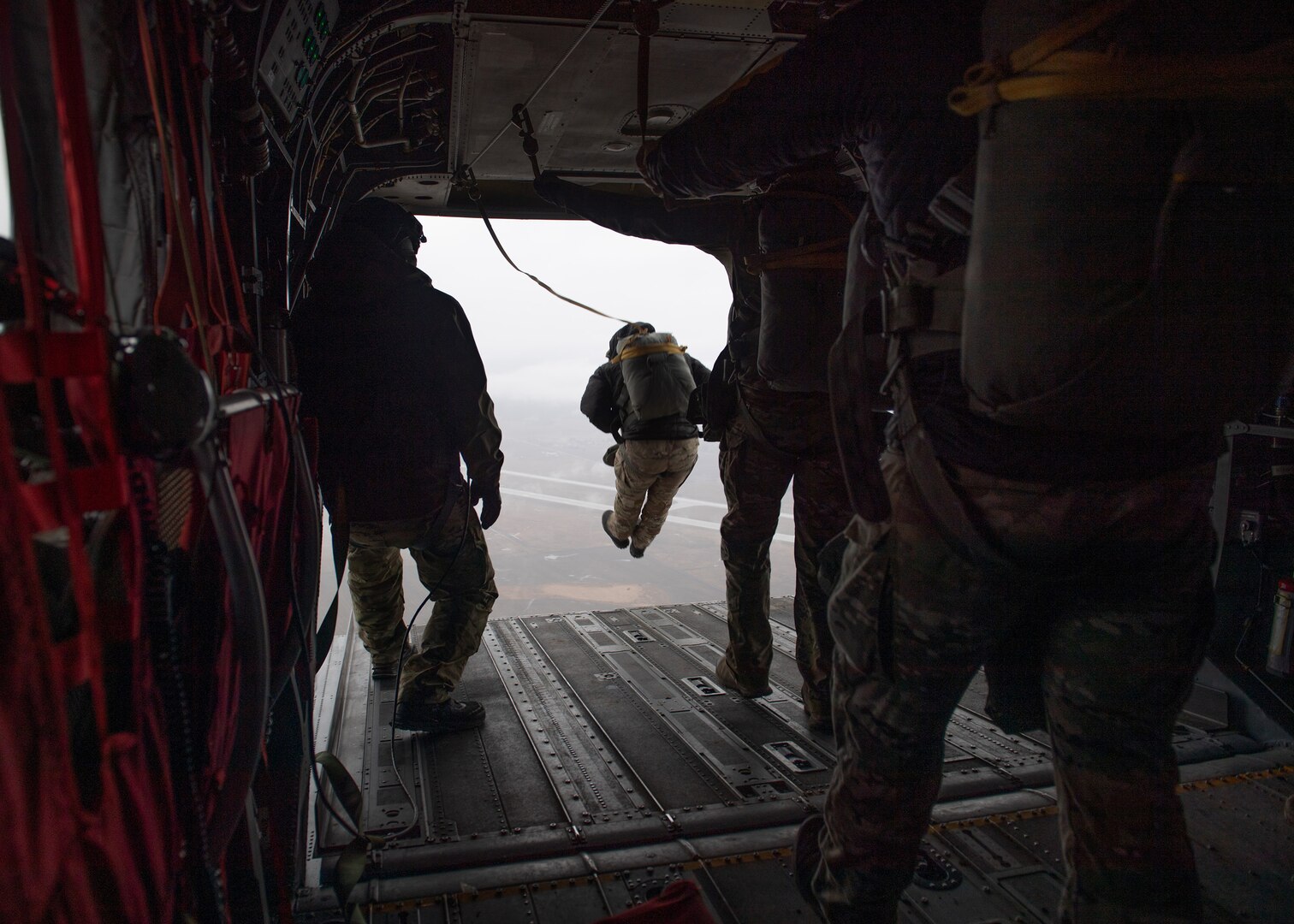 A member of the 116th Air Support Operations Squadron static line parachutes out of a CH-47 Chinook at Fairchild Air Force Base, Spokane, Wash., Feb. 5, 2024.