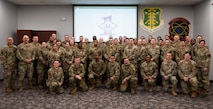 Members of Team Minot attending the First Sergeant Symposium pose for a group photo at Minot Air Force Base, North Dakota, Feb. 22, 2024. During the event guest speakers delved into various topics crucial for effective leadership such as emphasizing the importance of emotional intelligence, counseling techniques, and addressing tough issues. (U.S. Air Force photo by Airman 1st Class Luis Gomez)