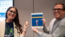 Department of Defense Einstein Fellow Melissa Thompson and former Einstein Fellow Tom Jenkins display a STEM-focused student book activity in West Bethesda, Md., on Feb. 22, 2024.