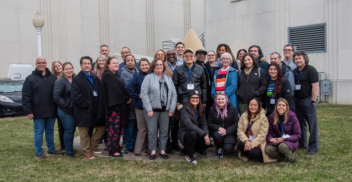 Department of Defense STEM Ambassadors stand together for a group photo outside the David Taylor Model Basin (DTMB) in West Bethesda, Md., on Feb. 22, 2024.