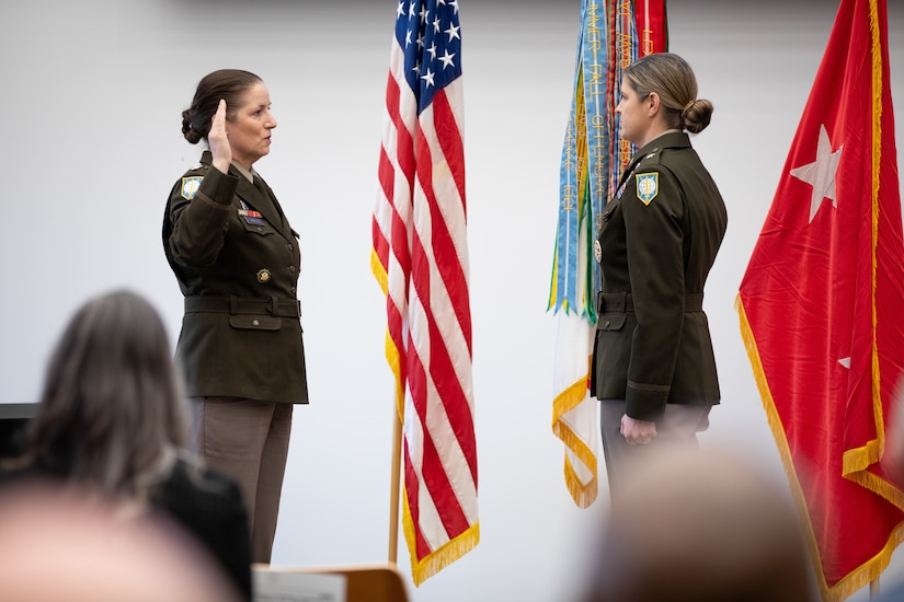 U.S. Army Reserve Maj. Gen Dustin Shulz (left), director of intelligence, U.S. Southern Command, administers the oath of office to U.S. Army Reserve Brig. Gen. Melissa Adamski (right), commander, Military Intelligence Readiness Command, during a promotion ceremony.