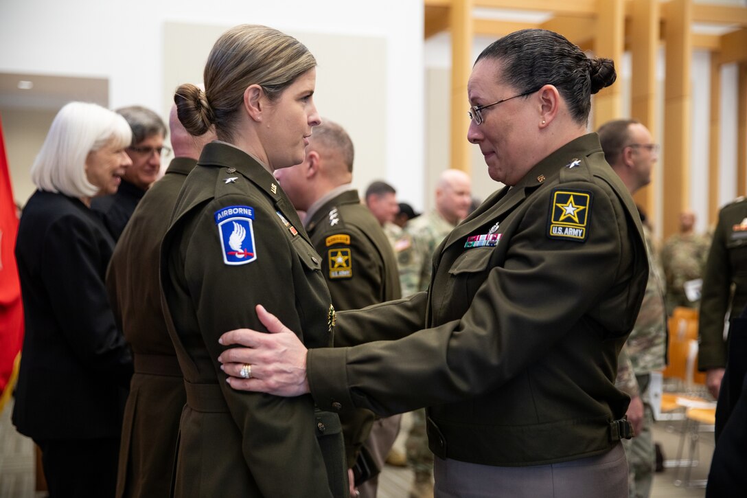 .S. Army Reserve Brig. Gen. Aida Borras congratulates U.S. Army Reserve Brig. Gen. Melissa Adamski, commander, Military Intelligence Readiness Command.