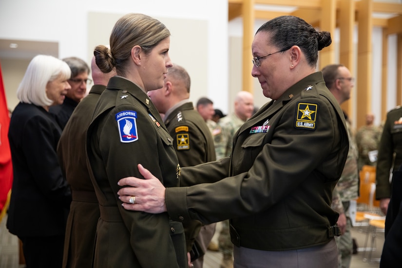 .S. Army Reserve Brig. Gen. Aida Borras congratulates U.S. Army Reserve Brig. Gen. Melissa Adamski, commander, Military Intelligence Readiness Command.